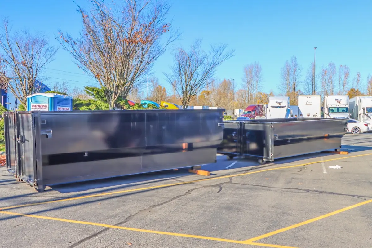 Professional dumpster rental service with roll-off container on residential driveway in Morgantown